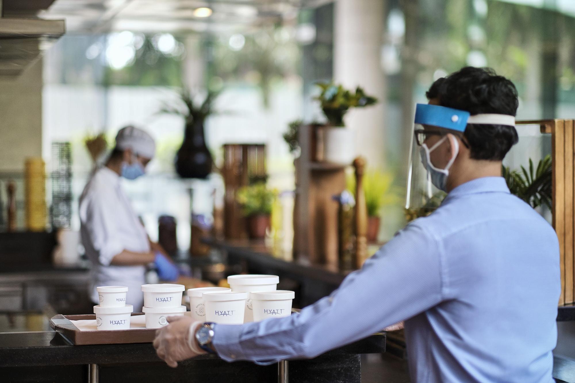 Hyatt Centric Mg Road Bangalore Exterior photo A restaurant employee wearing a face shield