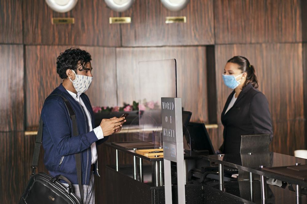 Hyatt Centric Mg Road Bangalore Exterior photo A hotel guest checking in at a hotel reception desk