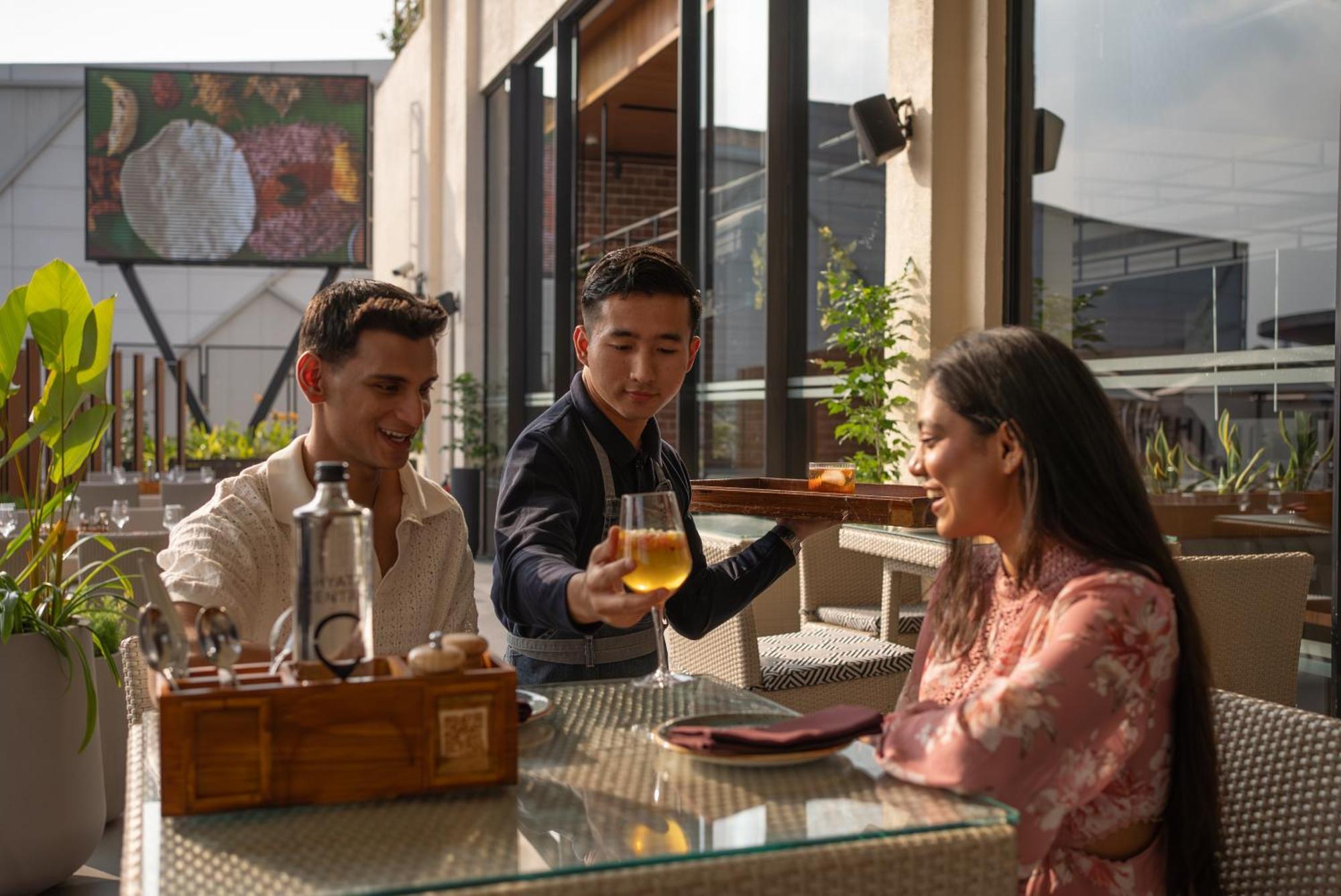 Hyatt Centric Mg Road Bangalore Exterior photo A waiter serving beer